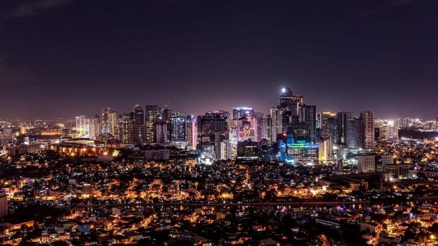 city with high rise buildings during night time