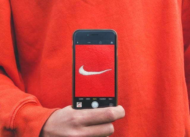 Thrive in the Vibrant Filipino Marketing Scene: How to Navigate and Triumph with Ad Agencies in the Philippines | Lime Digital Asia person holding iPhone taking picture on Nike label